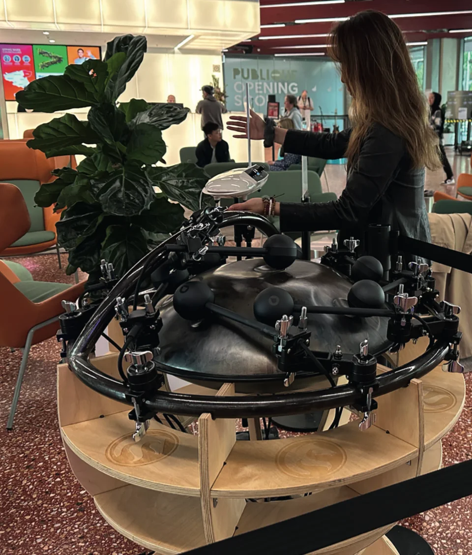 A participant using the gesture interface with Jon Drummond's robotic handpan